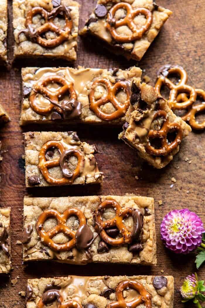 Chocolate Peanut Butter Pretzel Blondies | halfbakedharvest.com #peanutbutter #chocolate #pretzels #fall #autumn #dessert side angled close up photo of Chocolate Peanut Butter Pretzel Blondie broken in half