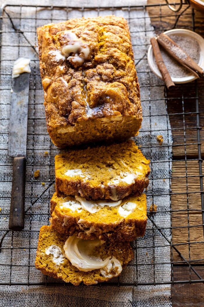 Cream Cheese Swirled Pumpkin Bread with Salted Maple Butter | halfbakedharvest.com #easyrecipes #pumpkinbread #pumpkin #fallrecipes overhead close up photo of Cream Cheese Swirled Pumpkin Bread with 3 slices of bread cut