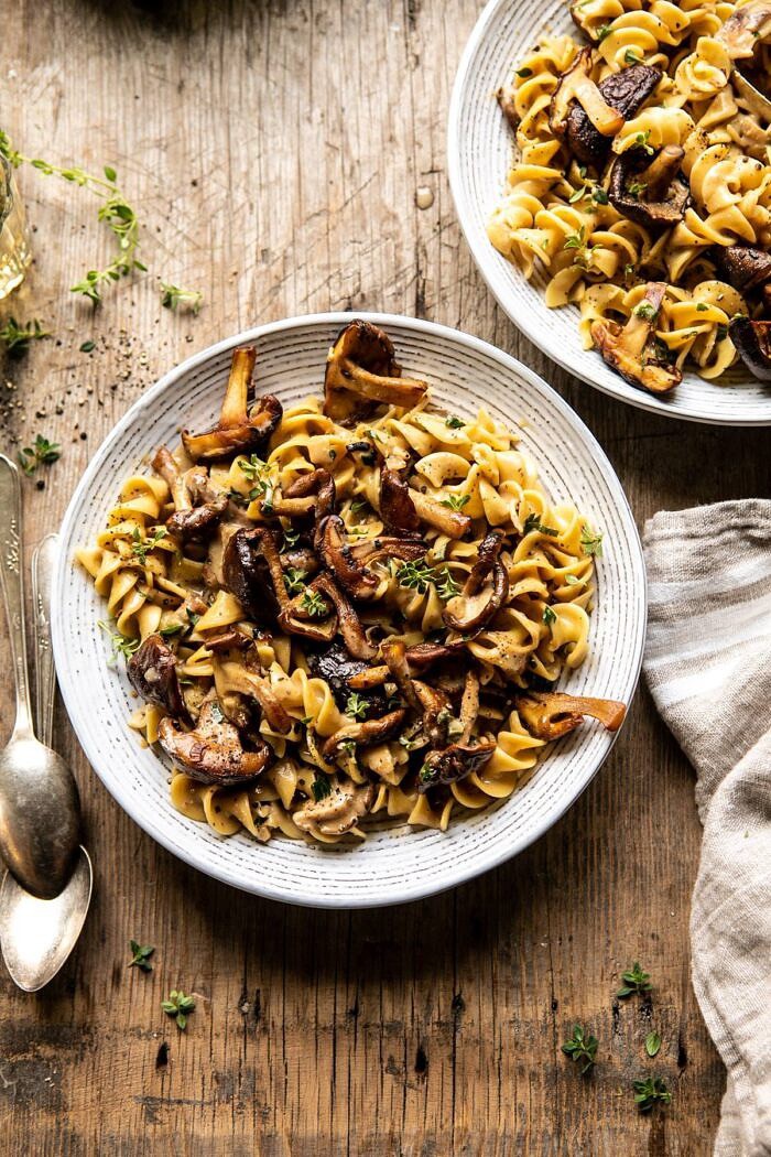 overhead photo of Herby Buttered Mushroom Stroganoff with 2 bowls and 2 spoons in photo