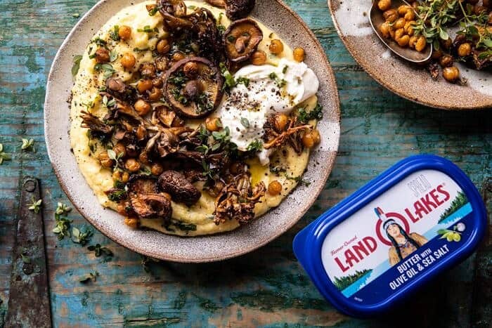 Pesto Polenta with Thyme Roasted Mushrooms and Chickpeas | halfbakedharvest.com #pesto #polenta #mushrooms #easyrecipes horizontal photo of Pesto Polenta with Thyme Roasted Mushrooms and Chickpeas and butter in photo