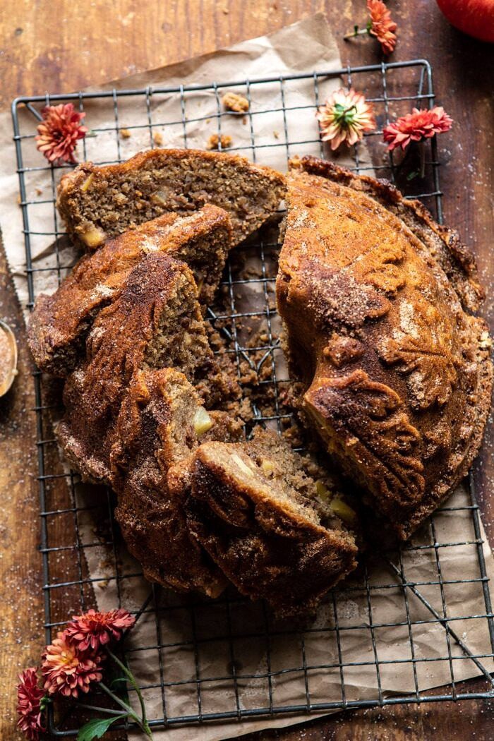 overhead photo of Spiced Pecan Apple Cider Doughnut Cake with multiple slices cut