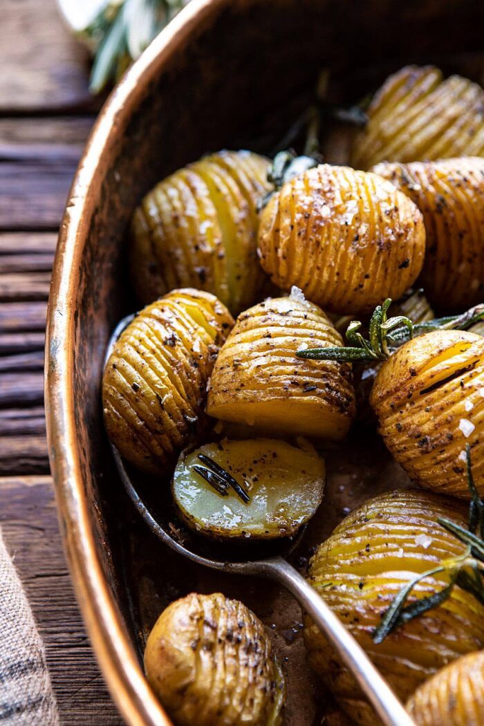 Crispy Rosemary Butter Roasted Potatoes | halfbakedharvest.com #potatoes #fall #autumn #Thanksgiving #Christmas side angled photo of Crispy Rosemary Butter Roasted Potatoes butter on potatoes