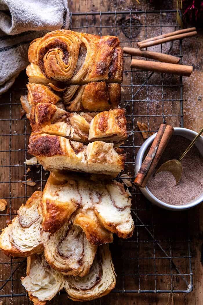 Easy Swirled Cinnamon Sugar Croissant Loaf | halfbakedharvest.com #cinnamon #fall #bread #croissants overhead photo of Easy Swirled Cinnamon Sugar Croissant Loaf with multiple slices cut