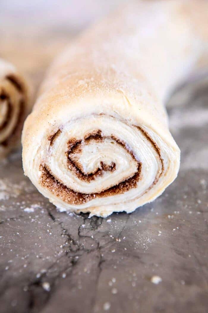 Easy Swirled Cinnamon Sugar Croissant Loaf | halfbakedharvest.com #cinnamon #fall #bread #croissants close up of dough log