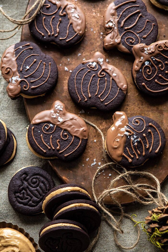 Peanut Butter Stuffed Chocolate Jack-O’-Lantern Cookies | halfbakedharvest.com #peanutbbutter #chocolate #cookies #halloween #thanksgiving overhead photo of Peanut Butter Stuffed Chocolate Jack-O’-Lantern Cookies on serving trey
