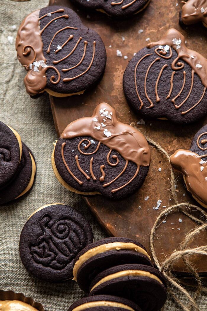 Peanut Butter Stuffed Chocolate Jack-O’-Lantern Cookies | halfbakedharvest.com #peanutbbutter #chocolate #cookies #halloween #thanksgiving overhead close up photo of Peanut Butter Stuffed Chocolate Jack-O’-Lantern Cookies on serving trey
