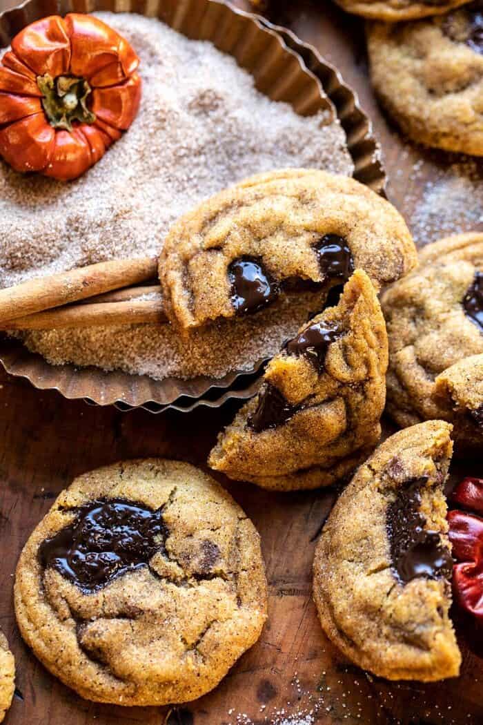 Pumpkin Butter Chocolate Chip Cookies | halfbakedharvest.com #pumpkin #cookies #chocolatechipcookies #fallrecipes side angle close up photo of broken in half Pumpkin Butter Chocolate Chip Cookie