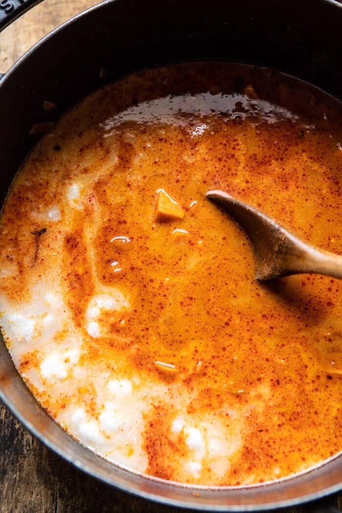 Sweet Potato Lentil Curry with Crispy Sesame Chickpeas | halfbkaedharvest.com #healthy #vegan #easyrecipes #fallrecipes overhead photo of Sweet Potato Lentil Curry in pot after adding coconut milk