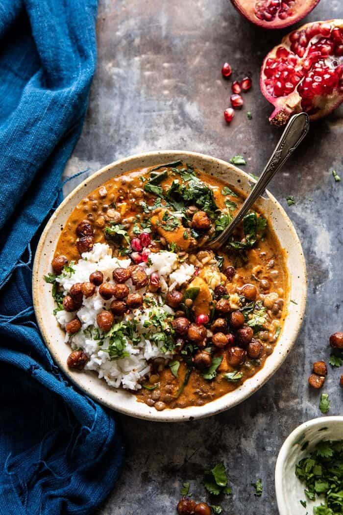 Sweet Potato Lentil Curry with Crispy Sesame Chickpeas | halfbkaedharvest.com #healthy #vegan #easyrecipes #fallrecipes overhead photo of Sweet Potato Lentil Curry with Crispy Sesame Chickpeas and spoon in bowl scooping up the curry