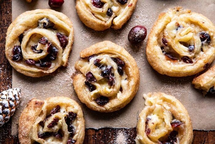 5 Ingredient Cranberry Brie Cinnamon Puff Pastry Swirls | halfbakedharvest.com #brie #cranberries #thanksgiving #christmas horizontal photo of 5 Ingredient Cranberry Brie Cinnamon Puff Pastry Swirls