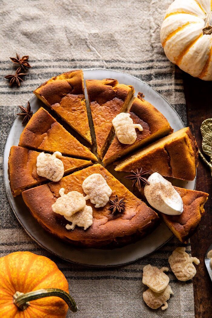 Burnt Basque Pumpkin Spice Cheesecake | halfbakedharvest.com #pumpkin #cheesecake #thanksgiving overhead photo of Burnt Basque Pumpkin Spice Cheesecake with multiple sliced of cheesecake cut