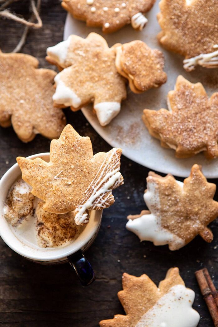 Chai Spiced Maple Sugar Cookies with Browned Butter Frosting | halfbakedharvest.com #cookies #thanksgiving #dessert #holiday #sugarcookies overhead photo of Chai Spiced Maple Sugar Cookie with Browned Butter Frosting resting on top of a mug of chai tea