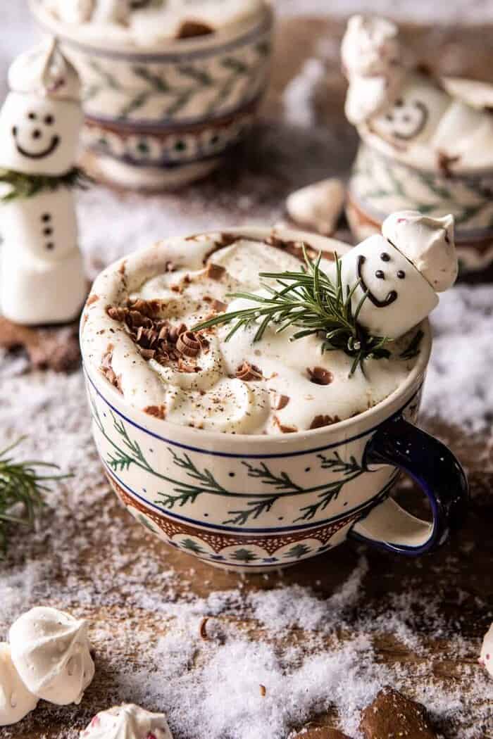 Creamy Coconut Hot Chocolate | halfbakedharvest.com #hotchocolate #easyrecipe #christmas #dessert front on photo of Creamy Coconut Hot Chocolate with melting snowman marshmallow in hot cocoa