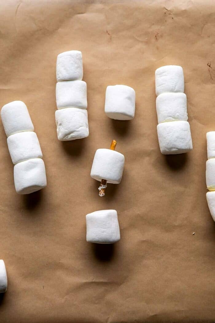 Creamy Coconut Hot Chocolate | halfbakedharvest.com #hotchocolate #easyrecipe #christmas #dessert process photo of assembling snowman marshmallows