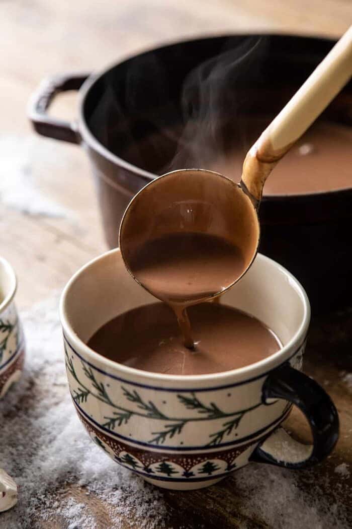 Creamy Coconut Hot Chocolate | halfbakedharvest.com #hotchocolate #easyrecipe #christmas #dessert Creamy Coconut Hot Chocolate being poured into hot cocoa mug