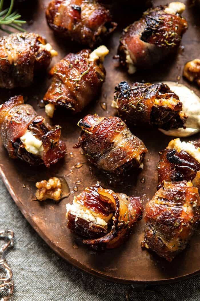 Goat Cheese Stuffed Bacon Wrapped Dates with Rosemary Honey | halfbakedharvest.com #dates #goatcheese #thanksgiving #appetizer overhead close up photo of Goat Cheese Stuffed Bacon Wrapped Date split in half to expose the goat filling