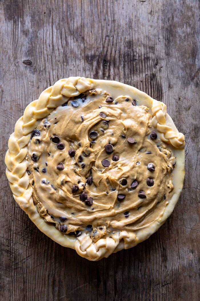 Gooey Chocolate Chip Cookie Pumpkin Pie | halfbakedharvest.com #cookiepie #thanksgiving #pumpkinpie overhead photo of Gooey Chocolate Chip Cookie Pumpkin Pie before baking