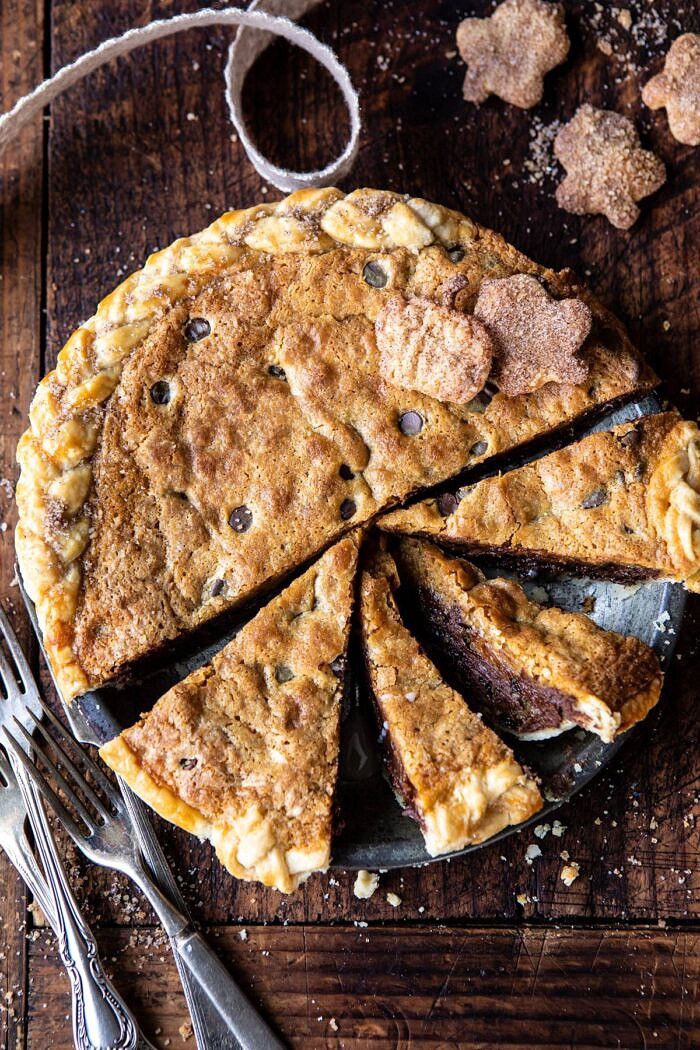 Gooey Chocolate Chip Cookie Pumpkin Pie | halfbakedharvest.com #cookiepie #thanksgiving #pumpkinpie overhead photo of Gooey Chocolate Chip Cookie Pumpkin Pie with pie slices cut