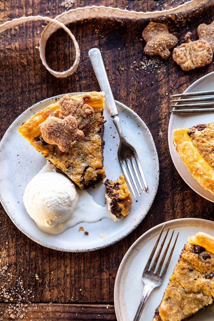 Gooey Chocolate Chip Cookie Pumpkin Pie | halfbakedharvest.com #cookiepie #thanksgiving #pumpkinpie photo of Gooey Chocolate Chip Cookie Pumpkin Pie with ice cream on plate