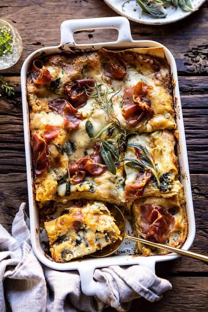 Roasted Butternut Squash and Spinach Lasagna | halfbakedharvest.com #lasagna #holiday #thanksgiving overhead photo of Roasted Butternut Squash and Spinach Lasagna with serving of lasagna removed and spoon in dish