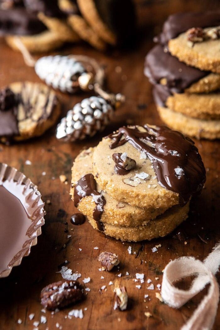 Slice n Bake Salted Chocolate Butter Pecan Cookies | halfbakedharvest.com #cookies #christmas #thanksgiving #chocolate side angle photo of Slice n Bake Salted Chocolate Butter Pecan Cookies with 3 cookies tacked one on top of the other