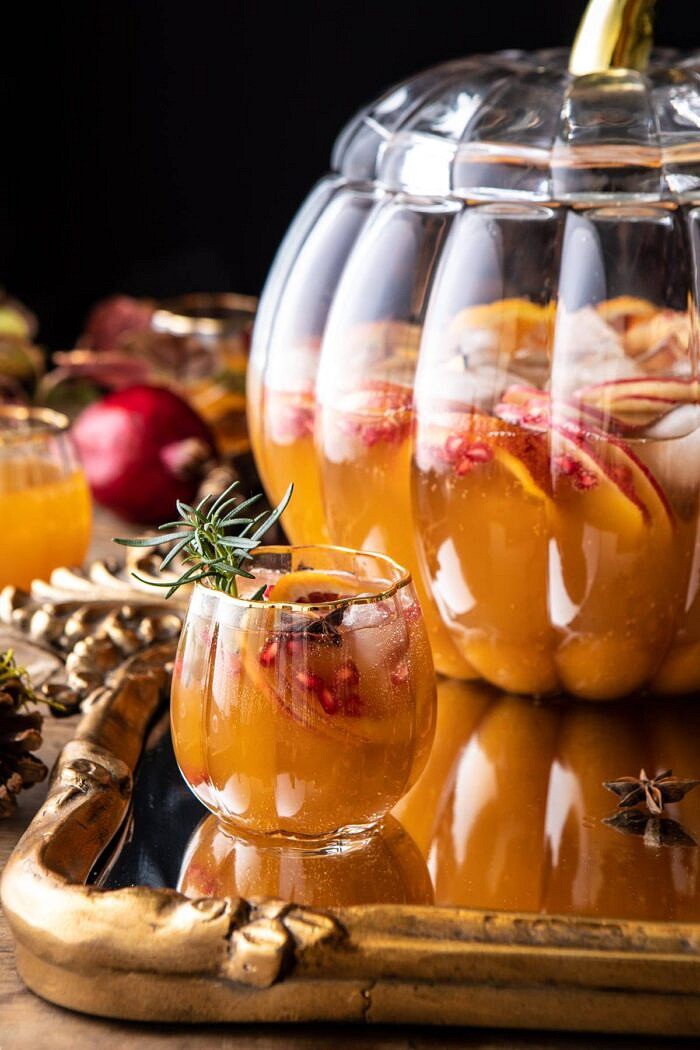 Thanksgiving Sangria | halfbakedharvest.com #thanksgiving #sangria #holiday close up photo of Thanksgiving Sangria in pumpkin glass