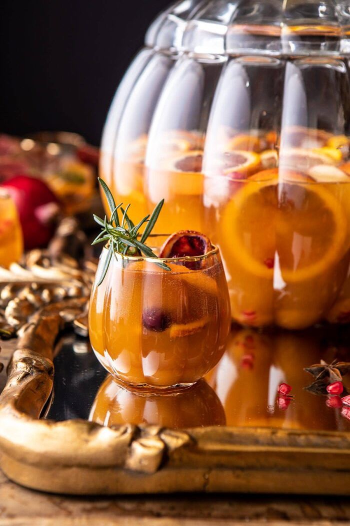 Thanksgiving Sangria | halfbakedharvest.com #thanksgiving #sangria #holiday close up photo of Thanksgiving Sangria in pumpkin glass