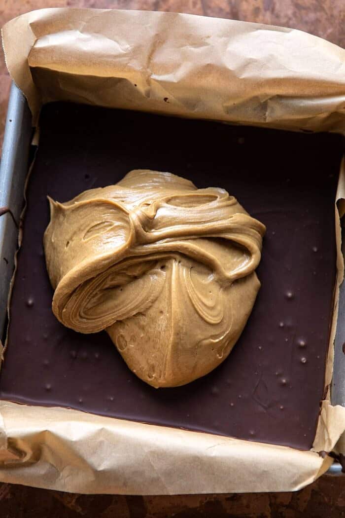 5 Ingredient Triple Decker Chocolate Peanut Butter Bars | halfbakedharvest.com #peanutbutter #chocolate overhead photo of 5 Ingredient Triple Decker Chocolate Peanut Butter Bars before adding the final chocolate layer