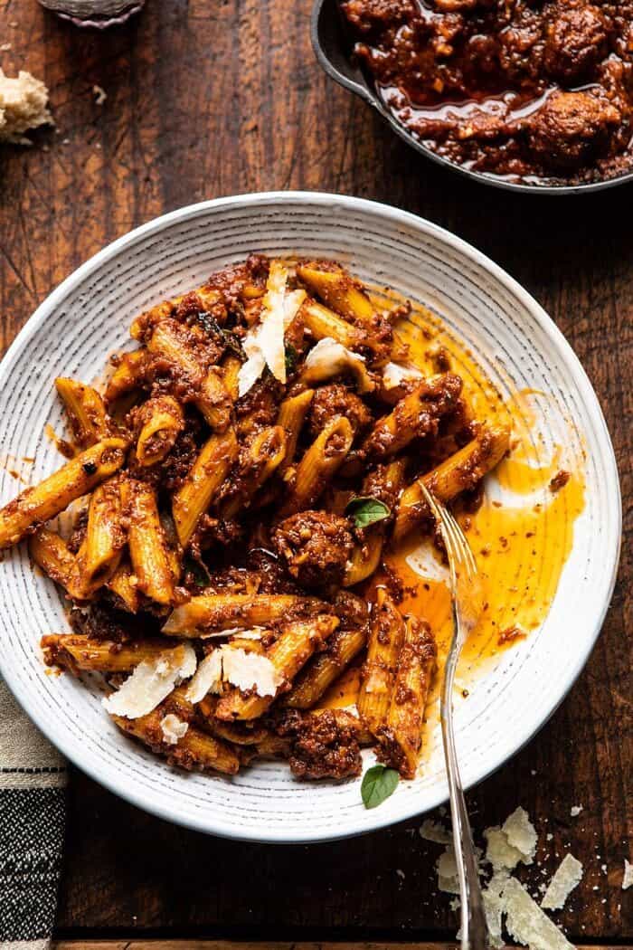 Best Super Easy Penne…with a lot of garlic | halfbakedharvest.com #penne #pasta #easyrecipes overhead close up photo of Best Super Easy Penne…with a lot of garlic with fork in serving bowl