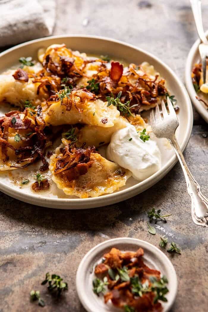 Cheddar Pierogies with Caramelized Onions and Bacon | halfbakedharvest.com #pierogi #homemade #Christmas side angled photo of Cheddar Pierogies with Caramelized Onions and Bacon