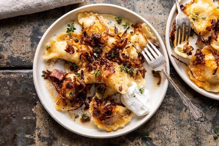 Cheddar Pierogies with Caramelized Onions and Bacon | halfbakedharvest.com #pierogi #homemade #Christmas horizontal photo of Cheddar Pierogies with Caramelized Onions and Bacon