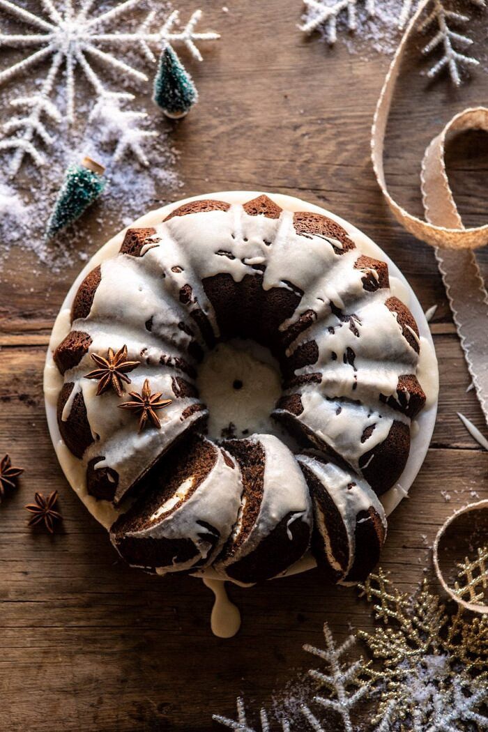Cream Cheese Swirled Chai Gingerbread Cake | halfbakedharvest.com #gingerbread #cake #Christmas #dessert overhead photo of Cream Cheese Swirled Chai Gingerbread Cake with 3 pieces of cake cut