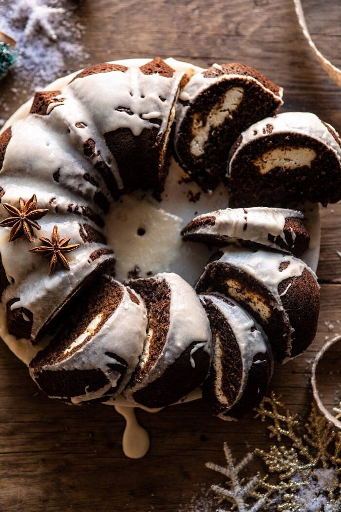 Cream Cheese Swirled Chai Gingerbread Cake | halfbakedharvest.com #gingerbread #cake #Christmas #dessert overhead close up photo of Cream Cheese Swirled Chai Gingerbread Cake with multiple slices of cake cut