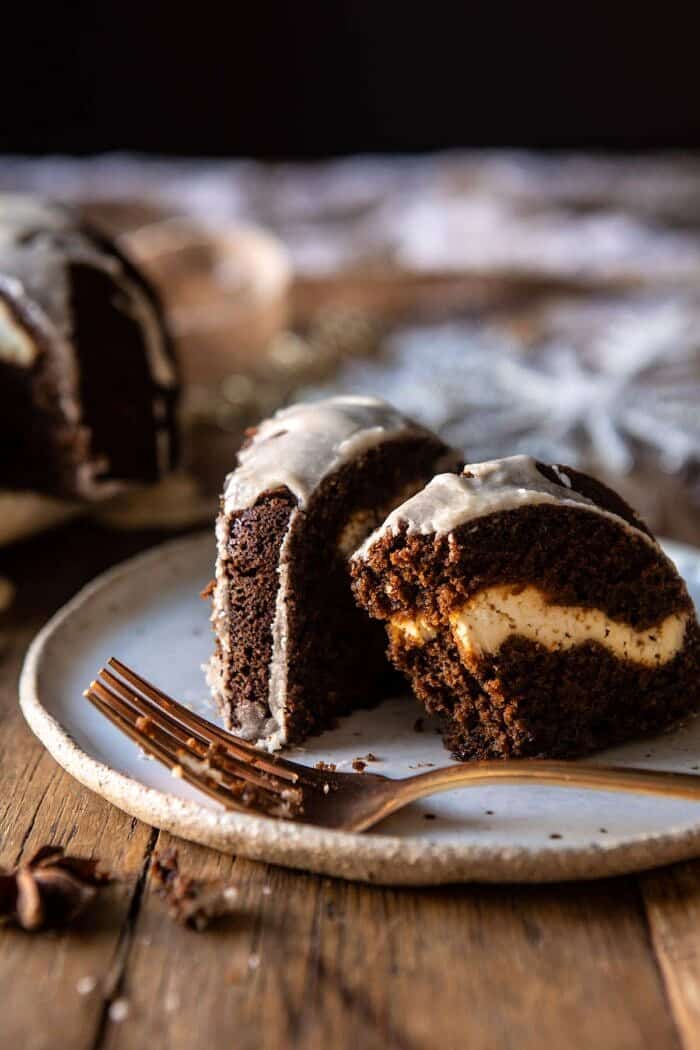 Cream Cheese Swirled Chai Gingerbread Cake | halfbakedharvest.com #gingerbread #cake #Christmas #dessert side angled photo of Cream Cheese Swirled Chai Gingerbread Cake with bite taken out of cake slice