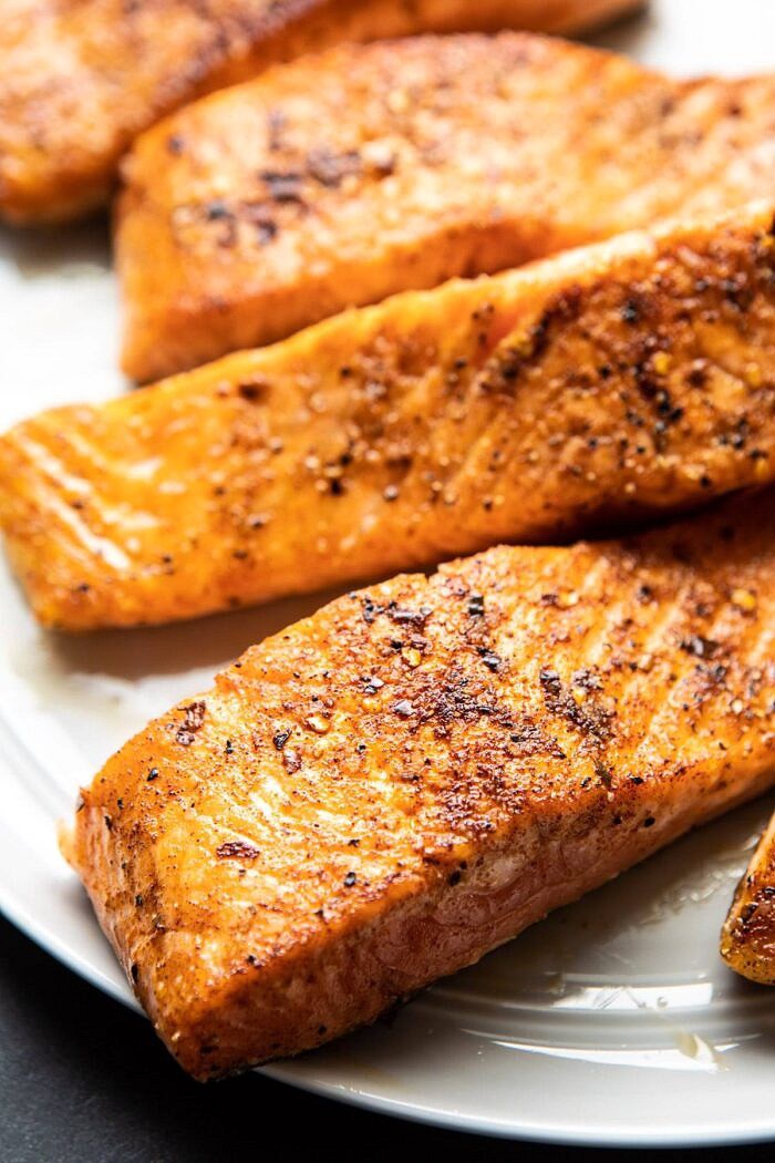 Creamy Spinach and Artichoke Salmon | halfbakedharvest.com #salmon #garlicbutter #easyrecipes salmon after searing in skillet