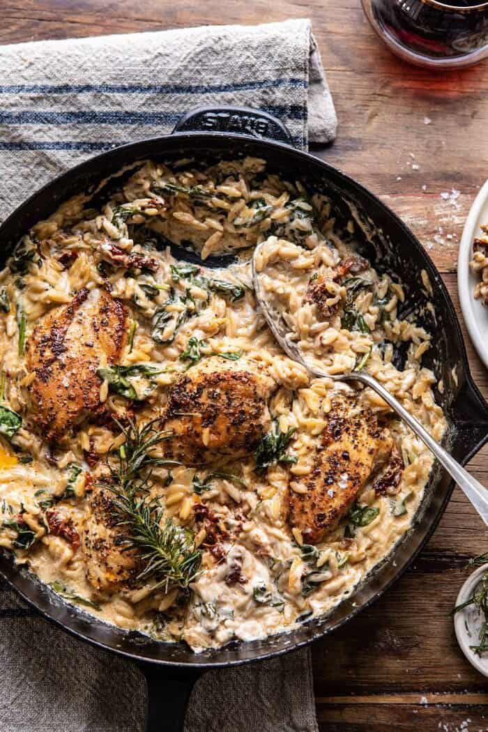 One Skillet Creamy Sun-Dried Tomato Chicken and Orzo | halfbakedharvest.com #skilletdinner #chicken #orzo overhead photo of One Skillet Creamy Sun-Dried Tomato Chicken and Orzo with spoon in skillet