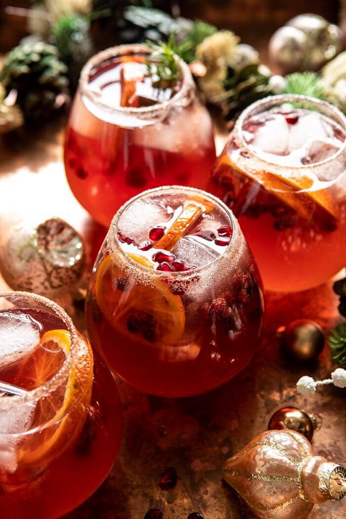 Sparkling Christmas Party Punch | halfbakedharvest.com #punch #christmasdrinks #cocktails side angled photo of Sparkling Christmas Party Punch in cocktail glasses