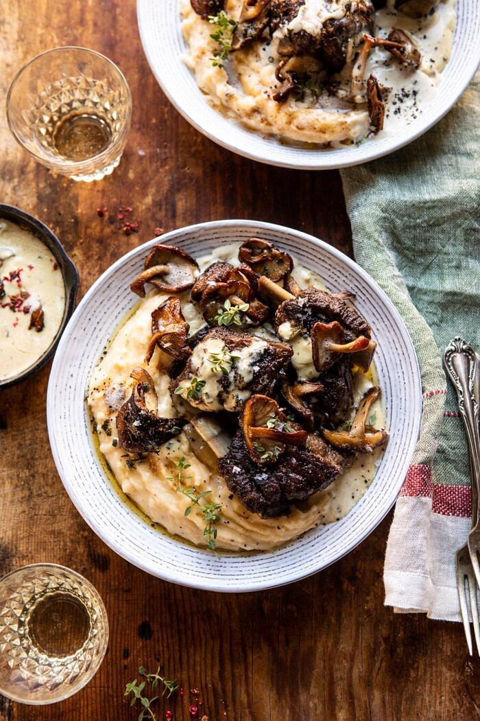 White Wine Braised Short Ribs with Buttered Mushroom Cream Sauce | halfbakedharvest.com #slowcooker #crockpot #shortribs #holiday #christmas overhead photo of White Wine Braised Short Ribs with Buttered Mushroom Cream Sauce