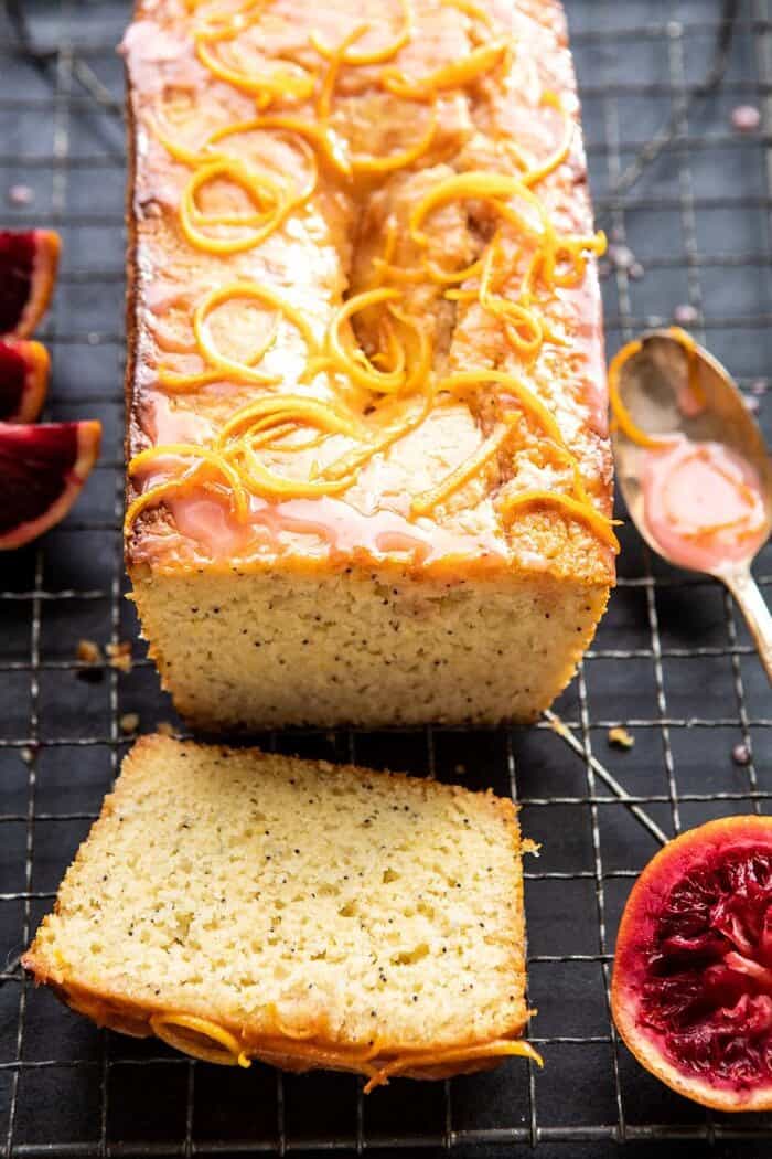 side angled photo of Lemon Poppyseed Cake with Citrus Honey Glaze with 1 piece of cake cut