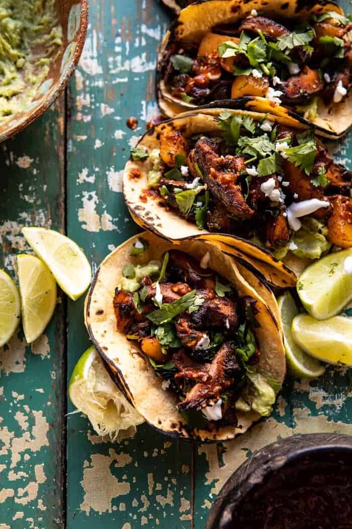 Mushroom Al Pastor Tacos with Garlic Lime Special Sauce | halfbakedharvest.com #vegan #mushrooms #tacos overhead close up photo of Mushroom Al Pastor Tacos with Garlic Lime Special Sauce