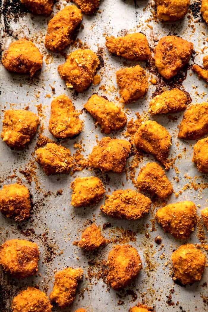 Oven Fried Cajun Popcorn Chicken with Creamy Honey Mustard | halfbakedharvest.com #chickenfingers #easyrecipes overhead photo of Oven Fried Cajun Popcorn Chicken on baking sheet