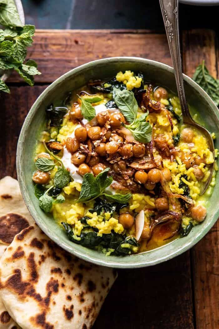 overhead close up photo of Creamy Golden Rice with Spiced Chickpeas and spoon in bowl