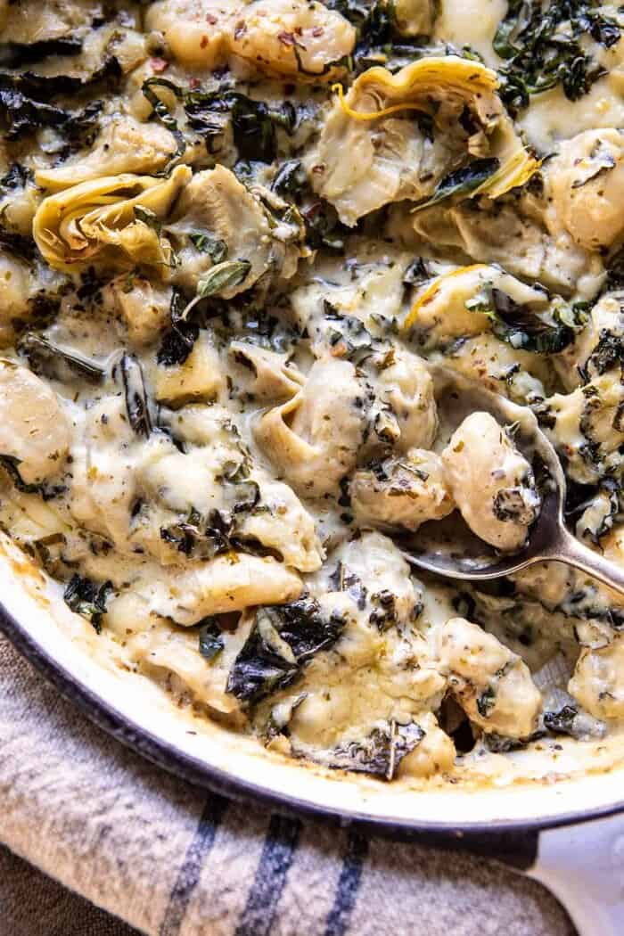 Skillet Baked Creamy Pesto Spinach and Artichoke Gnocchi | halfbakedharvest.com #gnocchi #easyrecipes #oneskillet