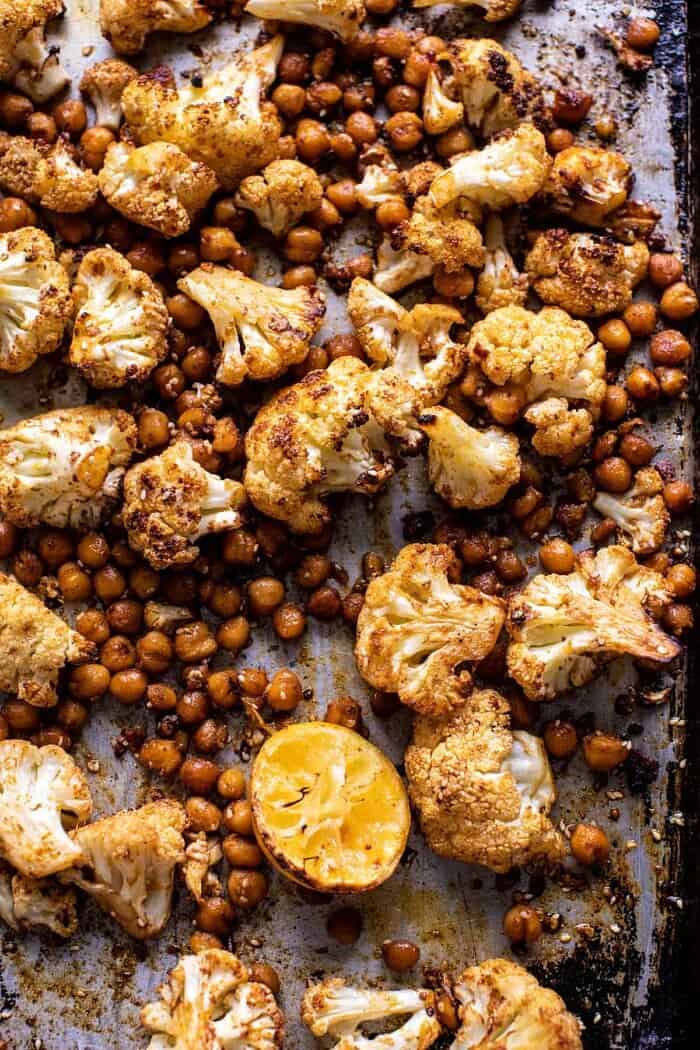 Cauliflower Shawarma with Green Tahini and Fried Halloumi | halfbakedharvest.com Cauliflower and chickpeas on baking sheet after roasting