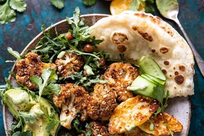 Cauliflower Shawarma with Green Tahini and Fried Halloumi | halfbakedharvest.com overhead close up horizontal photo of Cauliflower Shawarma with Green Tahini and Fried Halloumi