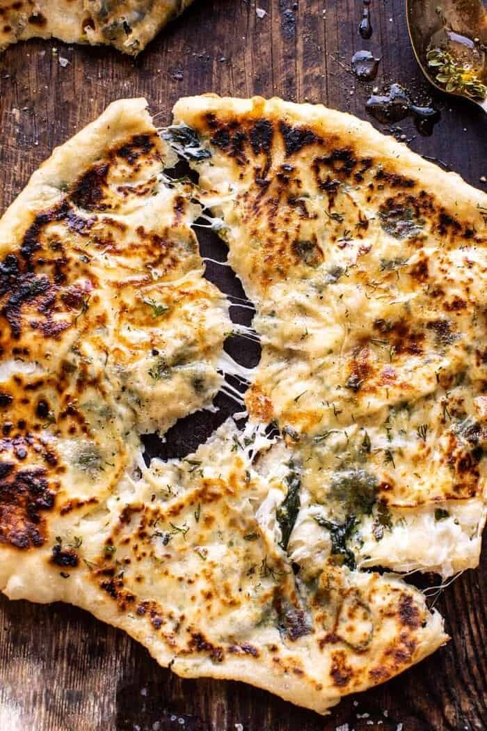 overhead close up photo of Cheesy Herb Stuffed Naan