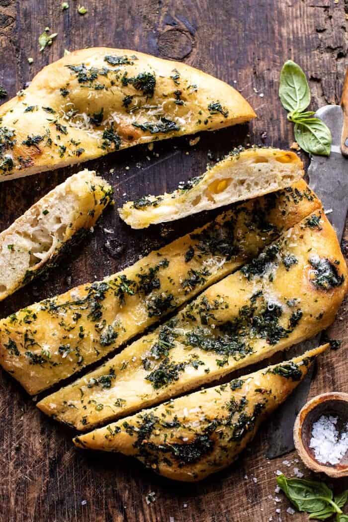 No Knead Rosemary Garlic Parmesan Bread | halfbakedharvest.com overhead photo of No Knead Rosemary Garlic Parmesan Bread with bread slices cut