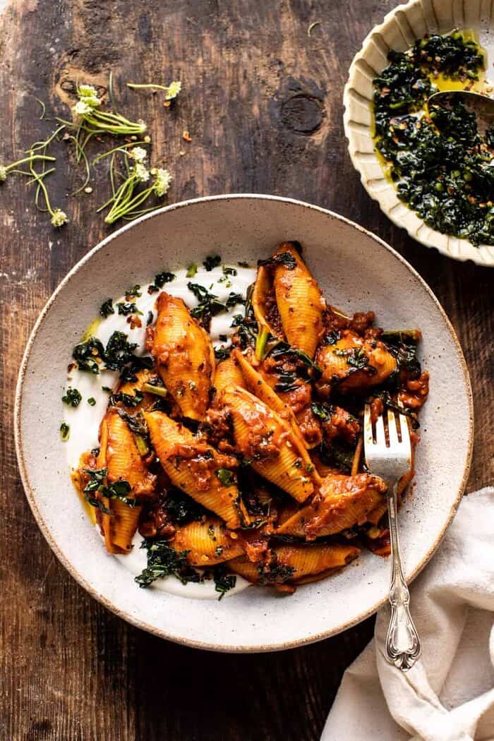 overhead photo of Unstuffed Spicy Tomato Basil Shells with Whipped Ricotta with fork in bowl 