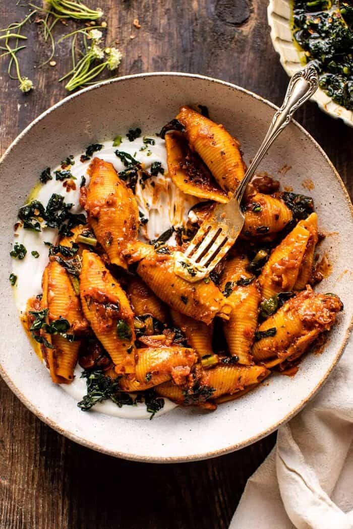 overhead photo of Unstuffed Spicy Tomato Basil Shells with Whipped Ricotta with fork in bowl 