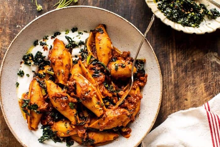 overhead close up photo of Unstuffed Spicy Tomato Basil Shells with Whipped Ricotta